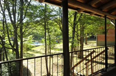 a screened in porch with a view of a park at Bosque Encantado Cabañas in Villa Icho Cruz