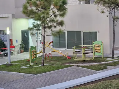 a park with a playground with a slide at Hermoso y comodo departamento Hospital Cardiologico Kempes Centro de Conveciones Cordoba in Cordoba