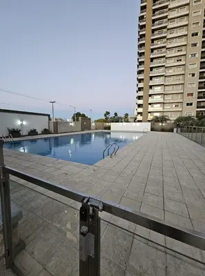 a swimming pool on the roof of a building at Hermoso y comodo departamento Hospital Cardiologico Kempes Centro de Conveciones Cordoba in Cordoba