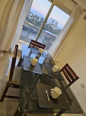 a glass table with chairs and mugs on top of it at Hermoso y comodo departamento Hospital Cardiologico Kempes Centro de Conveciones Cordoba in Cordoba