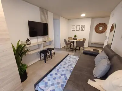 a living room with a couch and a tv at SERIETÁ 2 dormitorios con pileta y terraza panoramica in Cordoba