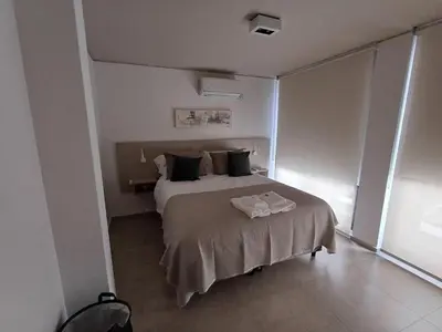 a bedroom with a bed in a room at SERIETÁ 2 dormitorios con pileta y terraza panoramica in Cordoba