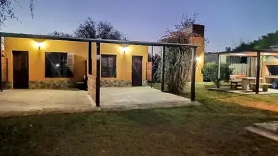 a house with a screened in porch in a yard at Complejo Rancho Aparte in Villa Rumipal