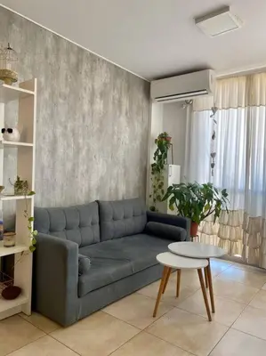 a living room with a blue couch and a table at Departamento Matilda - B Gral Paz Cba in Cordoba