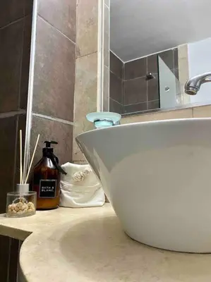 a bathroom counter with a white sink and a mirror at Departamento Matilda - B Gral Paz Cba in Cordoba