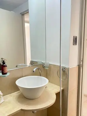 a bathroom with a bowl sink and a mirror at Departamento Matilda - B Gral Paz Cba in Cordoba