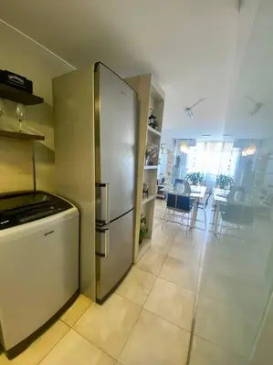 a kitchen with a stainless steel refrigerator and a dining room at Departamento Matilda - B Gral Paz Cba in Cordoba