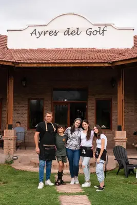 a group of people standing in front of a building at Ayres del Golf Posada-Restó in Merlo