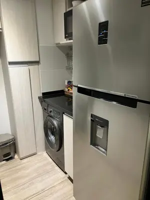 a kitchen with a refrigerator and a washing machine at Premium tower apart Parking gratis in Cordoba