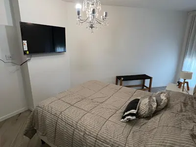 a cat laying on a bed in a bedroom at Premium tower apart Parking gratis in Cordoba
