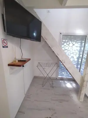 a living room with a tv and a window at Schönes Loft VGB in Villa General Belgrano