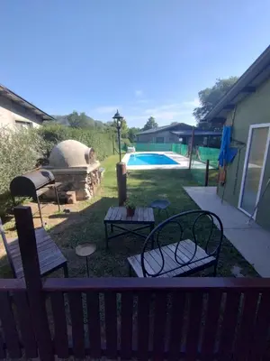 a backyard with a grill and a swimming pool at Schönes Loft VGB in Villa General Belgrano