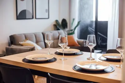 a table with wine glasses and plates on it at Tu espacio en la Cuidad in Cordoba