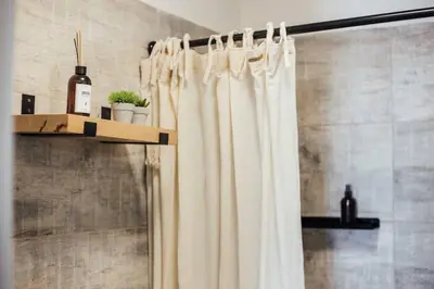 a bathroom with a shower curtain and a shelf at Tu espacio en la Cuidad in Cordoba
