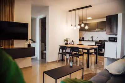 a living room and kitchen with a table and chairs at Tu espacio en la Cuidad in Cordoba