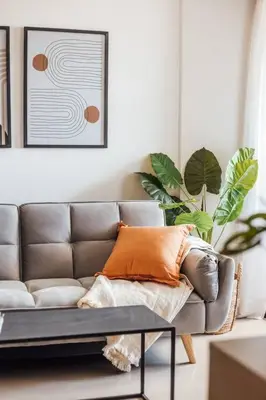 a living room with a couch and two plants at Tu espacio en la Cuidad in Cordoba