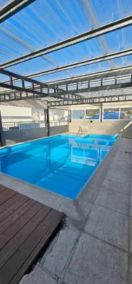 a large blue swimming pool on top of a building at MIRALEJOS CENTRO op AL in Villa Carlos Paz