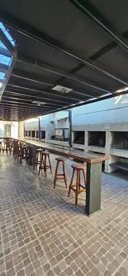 a row of wooden tables in a train station at MIRALEJOS CENTRO op AL in Villa Carlos Paz