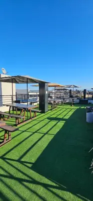 a picnic area with picnic tables and the beach at MIRALEJOS CENTRO op AL in Villa Carlos Paz