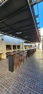 a group of tables and chairs in a building at MIRALEJOS CENTRO op AL in Villa Carlos Paz