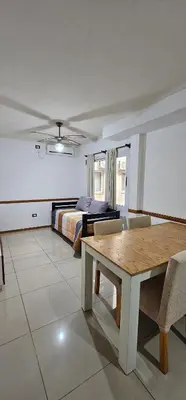 a bedroom with a bed and a table in a room at MIRALEJOS CENTRO op AL in Villa Carlos Paz