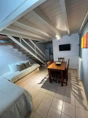 a bedroom with a bed and a table and a couch at Aparts Costalago in Villa Carlos Paz