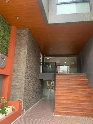 a building with a staircase in front of a building at Miralejos 7 Centro in Villa Carlos Paz