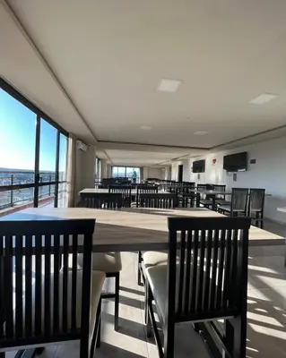 a dining room with chairs and a large wooden table at Miralejos 7 Centro in Villa Carlos Paz