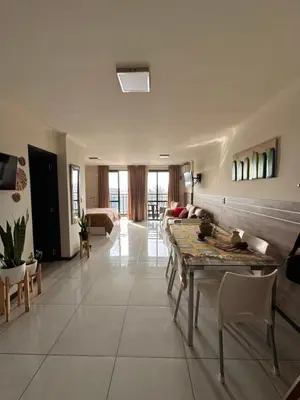 a living room with a table and a couch at Miralejos 7 Centro in Villa Carlos Paz