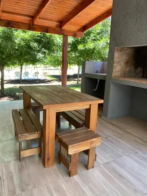 a wooden picnic table and bench on a patio at Cuatro vientos 2 in Santa Rosa de Calamuchita