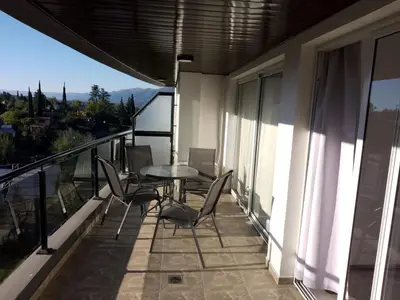 a balcony with a table and chairs on it at Veneto Village Departamento in Villa Parque Siquiman