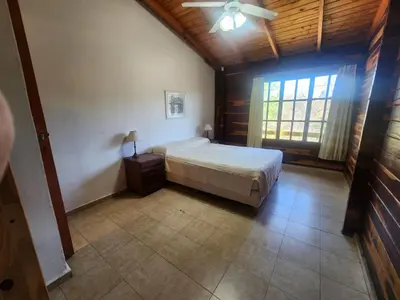 a bedroom with a bed and a ceiling fan at Complejo Costario in Tanti