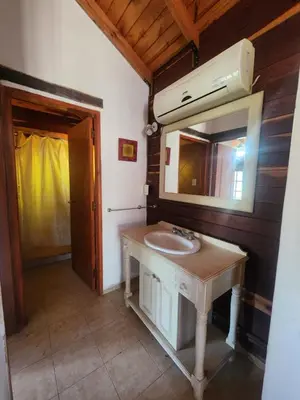 a bathroom with a sink and a mirror at Complejo Costario in Tanti