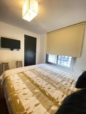 a large bed in a room with a window at Descanso de Liniers in Alta Gracia