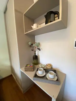 a shelf with two cups and saucers on a table at Descanso de Liniers in Alta Gracia