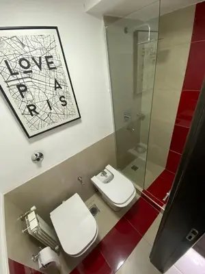 a bathroom with a toilet and a glass shower at Descanso de Liniers in Alta Gracia
