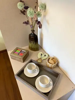 a table with a tray with plates and a vase with flowers at Descanso de Liniers in Alta Gracia