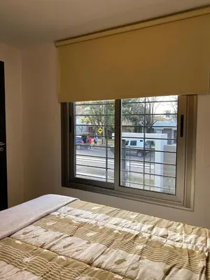 a bedroom with a window with a bed and a view at Descanso de Liniers in Alta Gracia