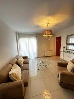 a living room with two couches and a table at Lugones House in Cordoba