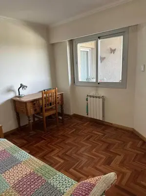 a room with a desk and a table and a window at Lugones House in Cordoba