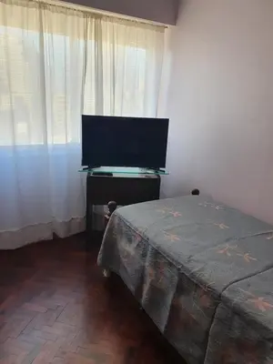 a bedroom with a bed and a flat screen tv at Rosa de los Vientos - Duarte Quirós in Cordoba