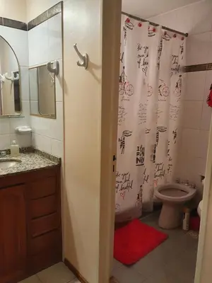 a bathroom with a shower with writing on the shower curtain at Rosa de los Vientos - Duarte Quirós in Cordoba