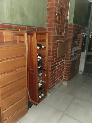 a wine rack with wine bottles in a brick wall at Rosa de los Vientos - Duarte Quirós in Cordoba