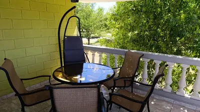 a table and chairs sitting on a balcony at Complejo BETELGEUSE in La Estancia