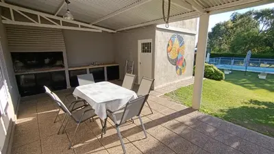 a table and chairs on a patio with a mosaic at Complejo BETELGEUSE in La Estancia