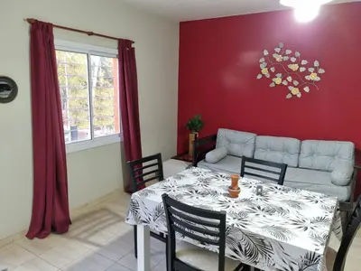 a living room with a table and a couch at Hermoso Departamento en Quines in Quines