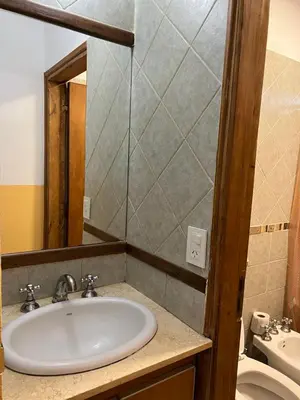 a bathroom with a sink and a toilet at El fogón de los amigos in Villa Carlos Paz