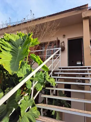 a building with stairs and plants in front of it at Dpto BenRos 5 pax - Complejo el Escorial in Villa Carlos Paz