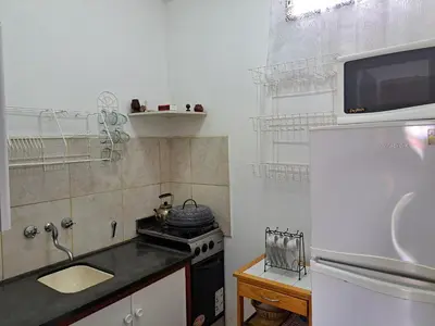 a small kitchen with a stove and a sink at Dpto BenRos 5 pax - Complejo el Escorial in Villa Carlos Paz