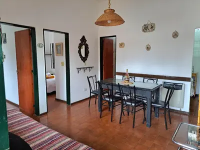 a dining room with a black table and chairs at Dpto BenRos 5 pax - Complejo el Escorial in Villa Carlos Paz